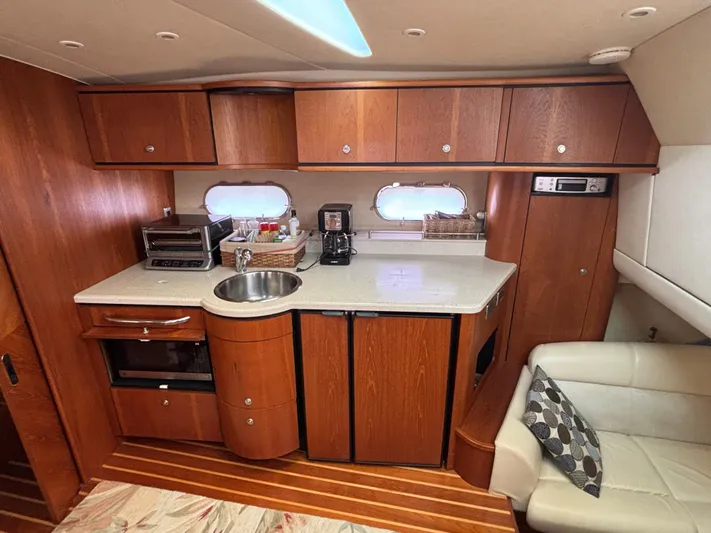 O Sea D Yacht Photos Pics 2008 Tiara Yachts 3900 Sovran interior with kitchenette, featuring wood cabinetry and modern appliances.