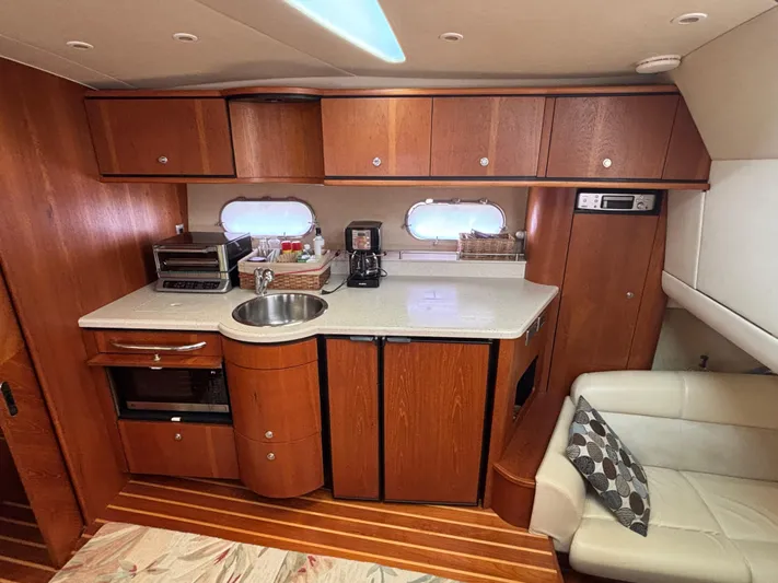 O Sea D Yacht Photos Pics 2008 Tiara Yachts 3900 Sovran interior with kitchenette, wood cabinetry, and seating area.