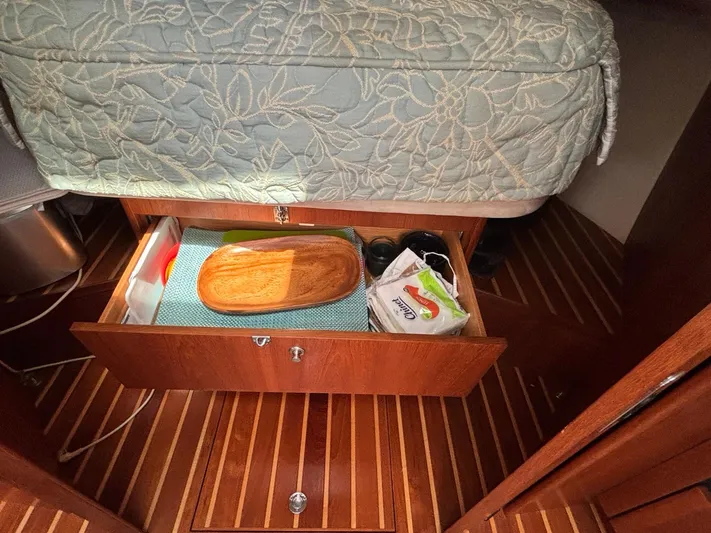O Sea D Yacht Photos Pics 2008 Tiara Yachts 3900 Sovran cabin drawer with storage items and wooden flooring.