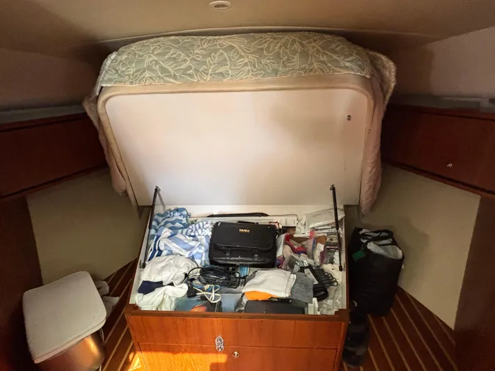 O Sea D Yacht Photos Pics 2008 Tiara Yachts 3900 Sovran cabin with open storage, revealing various items.