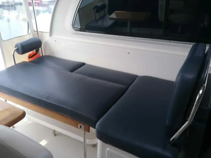 Lady In Blue Yacht Photos Pics 2012 Back Cove 30 boat interior with cushioned seating and table.