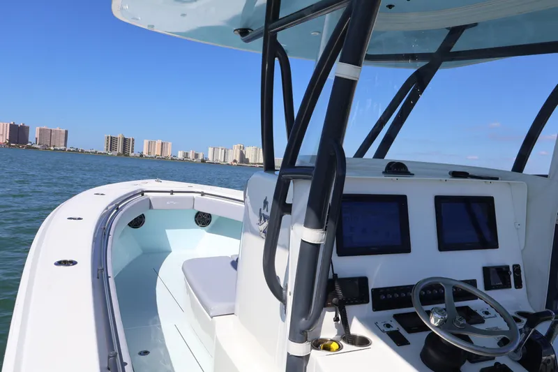 Wine Down Yacht Photos Pics 2017 Contender 35 ST boat interior with navigation controls, cruising near city skyline.