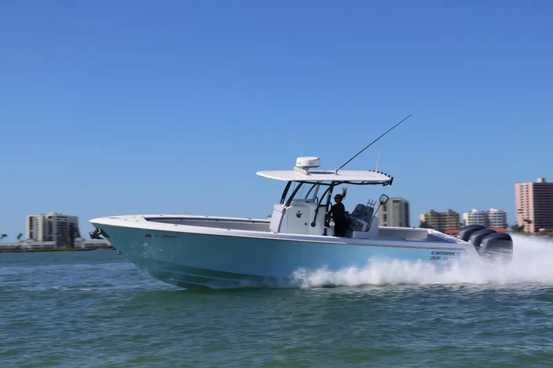 Wine Down Yacht Photos Pics 2017 Contender 35 ST boat cruising on water with city skyline in background.