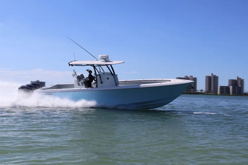Wine Down Yacht Photos Pics 2017 Contender 35 ST boat speeding on water with city skyline in background.