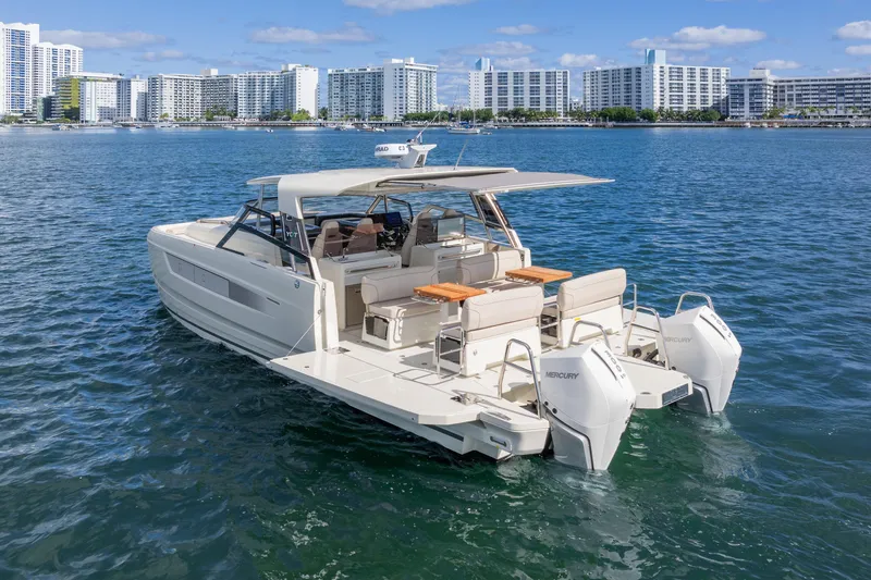 Yacht Photos Pics 2025 Catana YOT 36 motor yacht on water, city skyline in background.