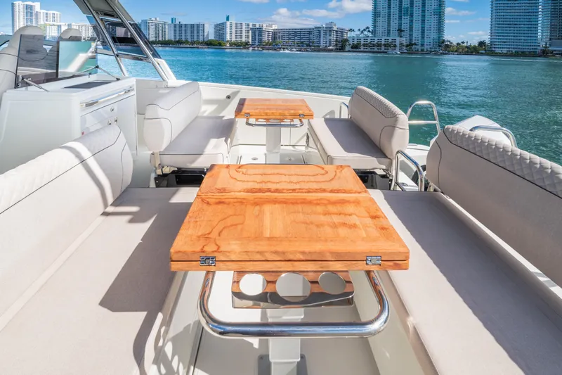  Yacht Photos Pics Luxurious Catana YOT 36 yacht interior with wooden tables, overlooking a scenic waterfront.