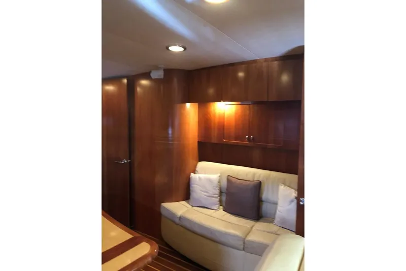 Eye Catcher Yacht Photos Pics 2004 Tiara Yachts 4400 Sovran interior with wooden cabinets and cozy seating area.