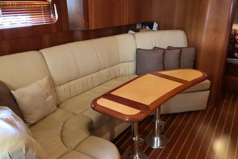 Eye Catcher Yacht Photos Pics Luxurious interior of 2004 Tiara Yachts 4400 Sovran with elegant seating and wooden table.