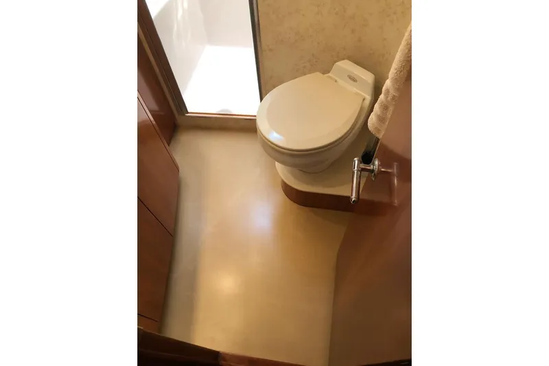 Eye Catcher Yacht Photos Pics Bathroom interior of 2004 Tiara Yachts 4400 Sovran, featuring a compact toilet.