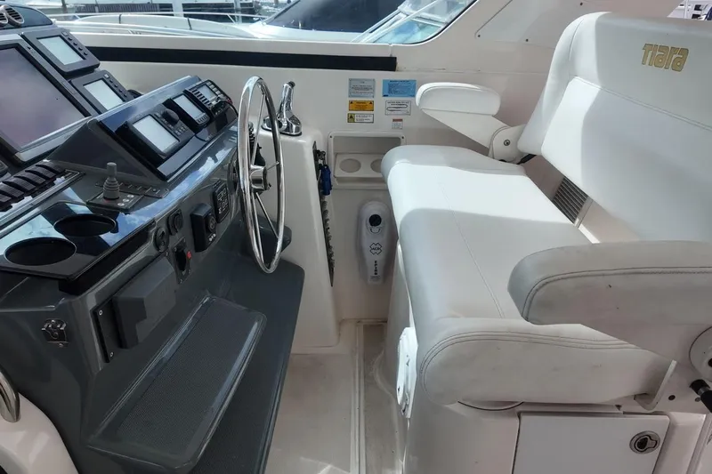 Eye Catcher Yacht Photos Pics Helm of 2004 Tiara Yachts 4400 Sovran with steering wheel and navigation controls.