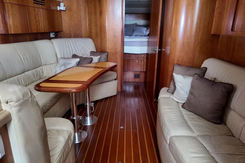 Eye Catcher Yacht Photos Pics Luxurious interior of 2004 Tiara Yachts 4400 Sovran with plush seating and wooden accents.