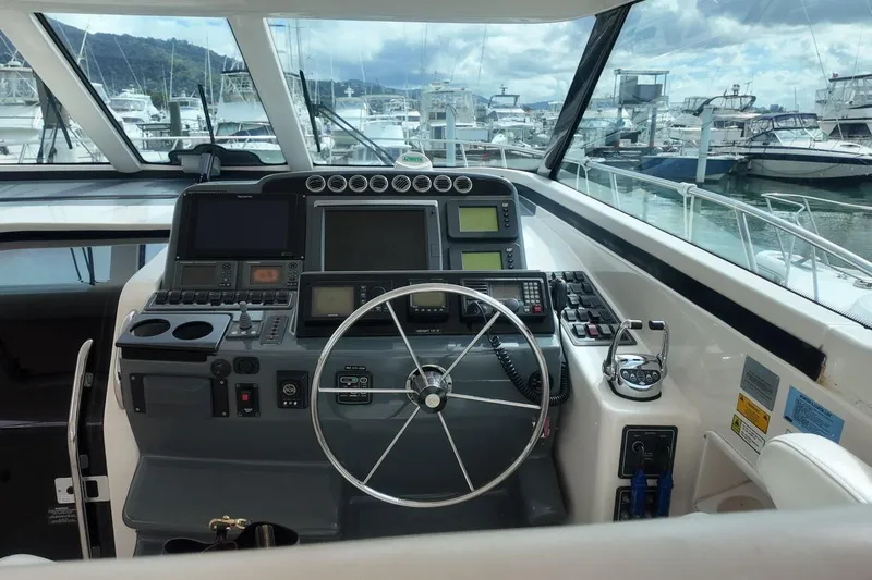 Eye Catcher Yacht Photos Pics Helm of 2004 Tiara Yachts 4400 Sovran with navigation equipment and steering wheel.