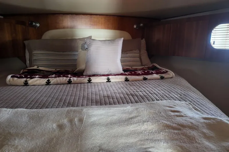 Eye Catcher Yacht Photos Pics Cozy cabin interior of 2004 Tiara Yachts 4400 Sovran with plush bedding.