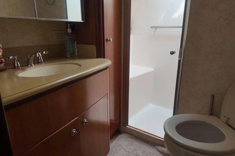 Eye Catcher Yacht Photos Pics Bathroom interior of 2004 Tiara Yachts 4400 Sovran with sink, toilet, and shower.