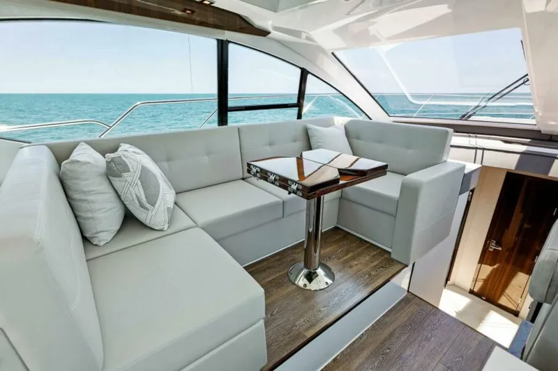 Mint 2 Bee Yacht Photos Pics Luxurious interior of 2022 Cruisers Yachts 50 Cantius with elegant seating and ocean view.