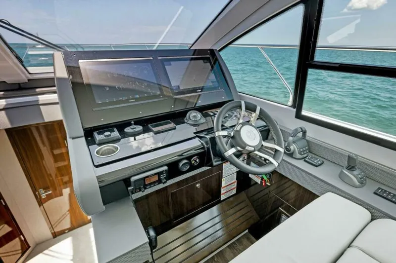 Mint 2 Bee Yacht Photos Pics Helm of 2022 Cruisers Yachts 50 Cantius with modern navigation equipment and ocean view.