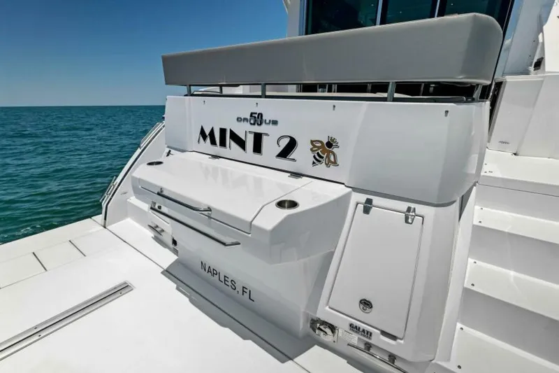 Mint 2 Bee Yacht Photos Pics 2022 Cruisers Yachts 50 Cantius, "Mint 2," docked in Naples, FL, ocean view.