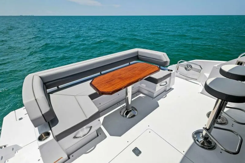 Mint 2 Bee Yacht Photos Pics Luxury seating area on 2022 Cruisers Yachts 50 Cantius, overlooking the ocean.