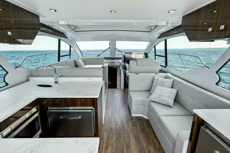 Mint 2 Bee Yacht Photos Pics Luxurious interior of 2022 Cruisers Yachts 50 Cantius with modern kitchen and seating area.