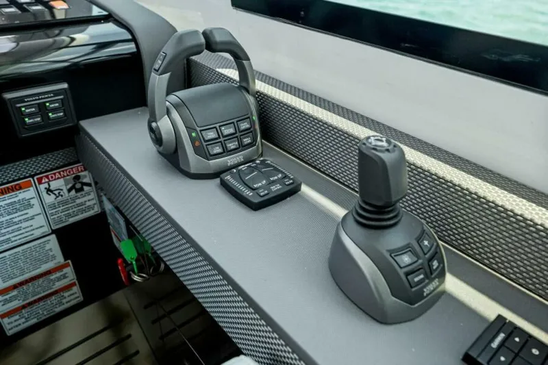 Mint 2 Bee Yacht Photos Pics Control panel of 2022 Cruisers Yachts 50 Cantius with joystick and throttle controls.