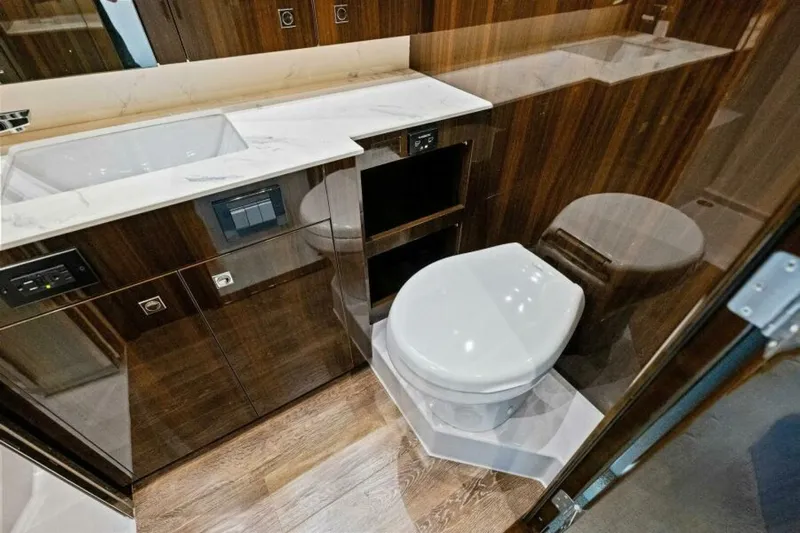 Mint 2 Bee Yacht Photos Pics Luxurious bathroom in 2022 Cruisers Yachts 50 Cantius with modern fixtures and wood accents.