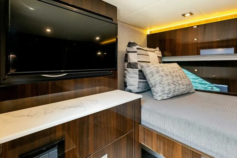 Mint 2 Bee Yacht Photos Pics Luxurious 2022 Cruisers Yachts 50 Cantius interior with TV, bed, and modern decor.