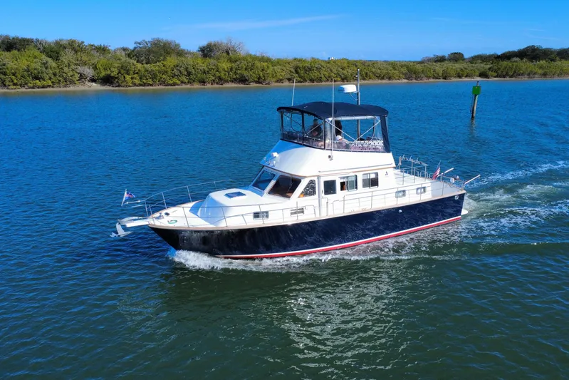  Yacht Photos Pics 2006 Albin 40 North Sea Cutter cruising on a serene blue waterway.