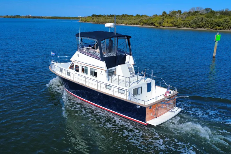  Yacht Photos Pics 2006 Albin 40 North Sea Cutter cruising on a serene blue waterway.