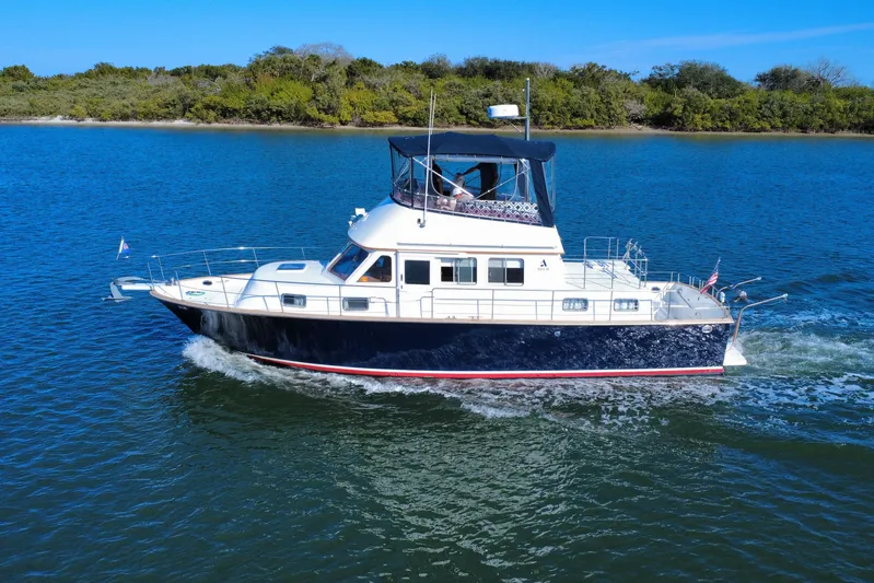 Yacht Photos Pics 2006 Albin 40 North Sea Cutter cruising on blue water near lush shoreline.