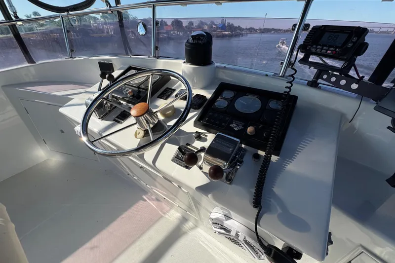  Yacht Photos Pics Helm of 2006 Albin 40 North Sea Cutter with steering wheel and navigation controls.