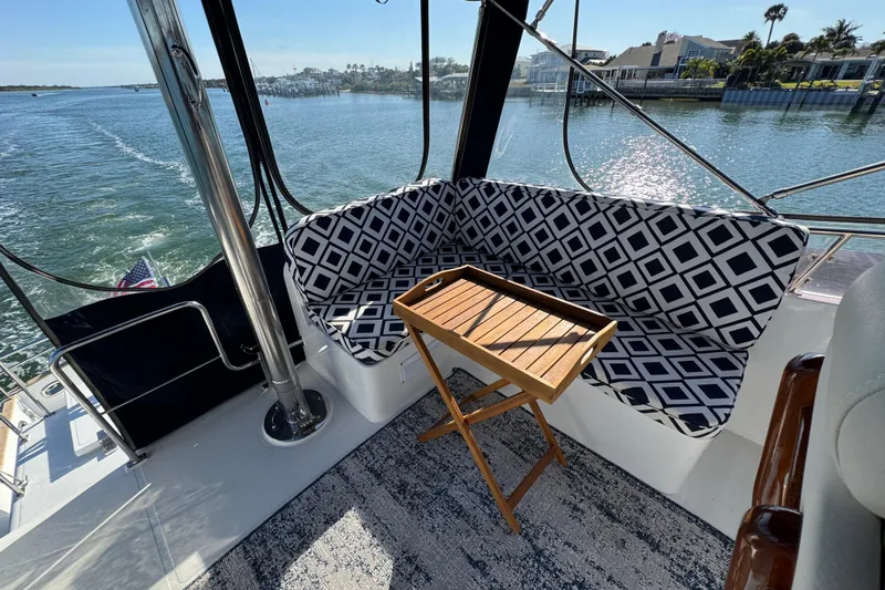  Yacht Photos Pics 2006 Albin 40 North Sea Cutter interior with patterned seating and wooden table, overlooking water.