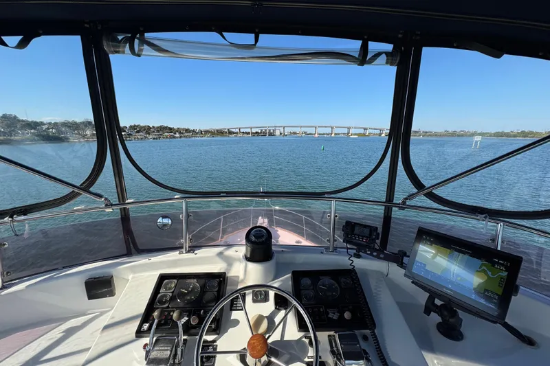  Yacht Photos Pics Helm view of 2006 Albin 40 North Sea Cutter on calm waters with bridge in background.