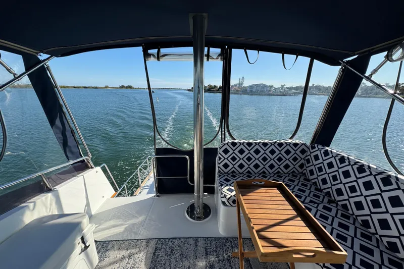  Yacht Photos Pics 2006 Albin 40 North Sea Cutter interior with patterned seating and wooden table on calm water.