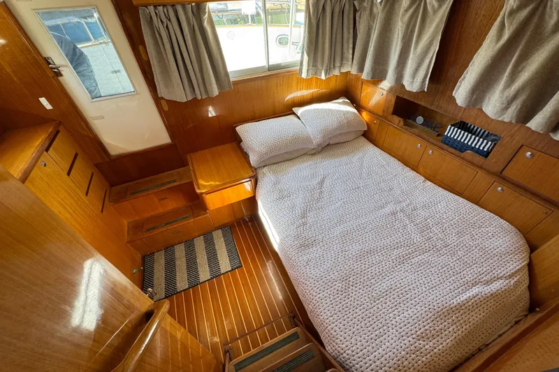  Yacht Photos Pics Cozy cabin interior of 2006 Albin 40 North Sea Cutter with wooden finish and bed.