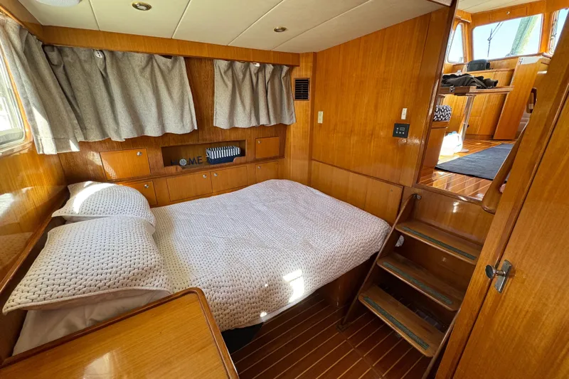  Yacht Photos Pics Cozy cabin interior of 2006 Albin 40 North Sea Cutter with wooden finish and bed.