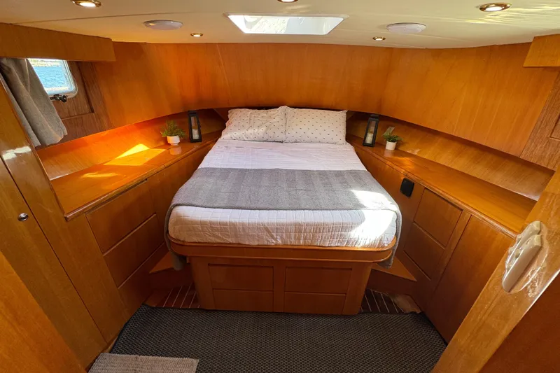  Yacht Photos Pics Cozy cabin interior of 2006 Albin 40 North Sea Cutter with wooden finish and double bed.