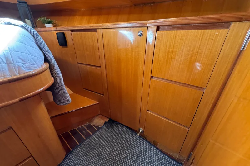  Yacht Photos Pics Interior of 2006 Albin 40 North Sea Cutter with wooden cabinetry and cozy bedding.