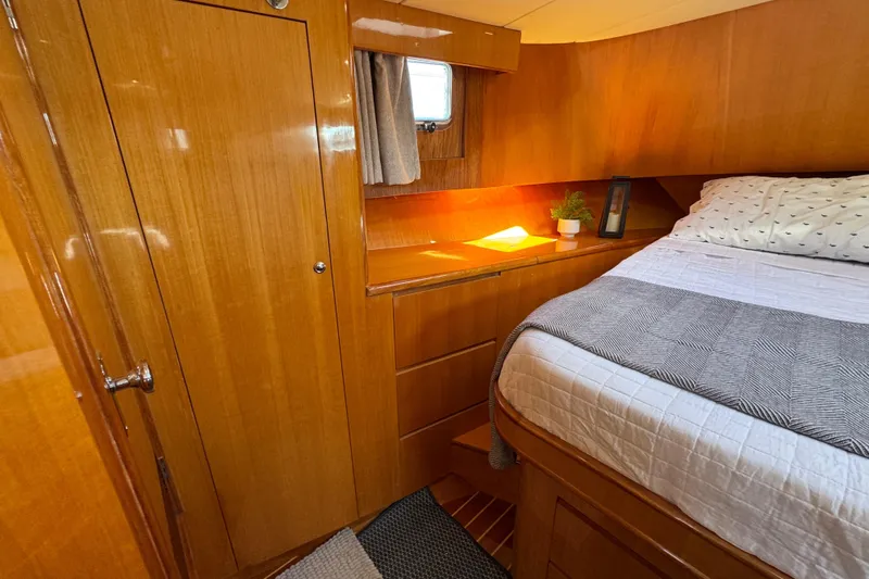  Yacht Photos Pics Cozy cabin interior of 2006 Albin 40 North Sea Cutter with wooden finish and bed.