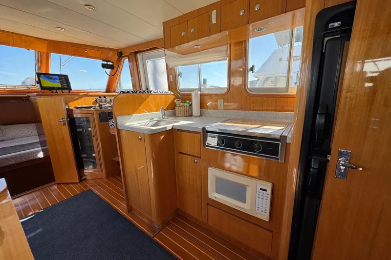  Yacht Photos Pics Interior of 2006 Albin 40 North Sea Cutter with kitchen and navigation area.