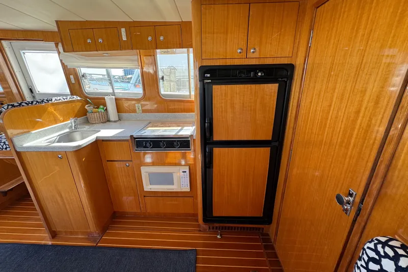  Yacht Photos Pics Interior of 2006 Albin 40 North Sea Cutter with kitchen amenities and wooden cabinetry.