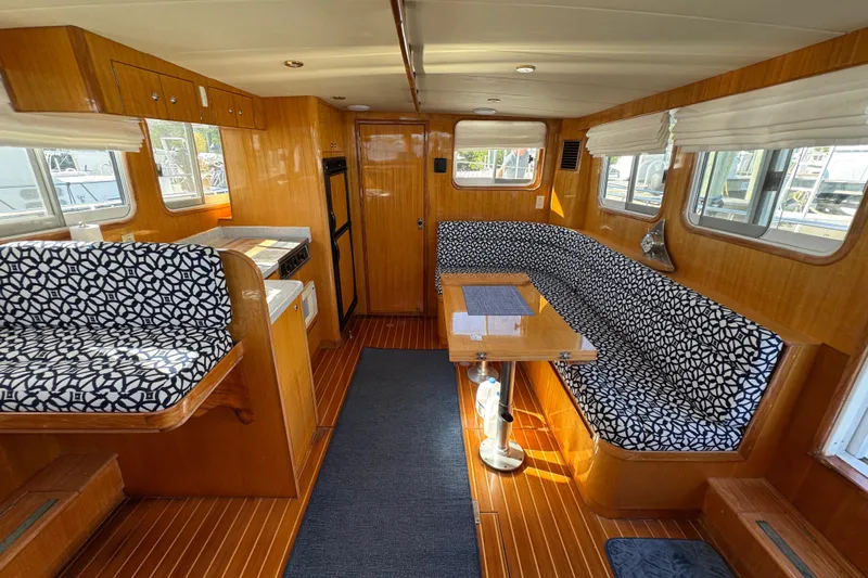  Yacht Photos Pics Interior of 2006 Albin 40 North Sea Cutter with patterned seating and wooden finishes.