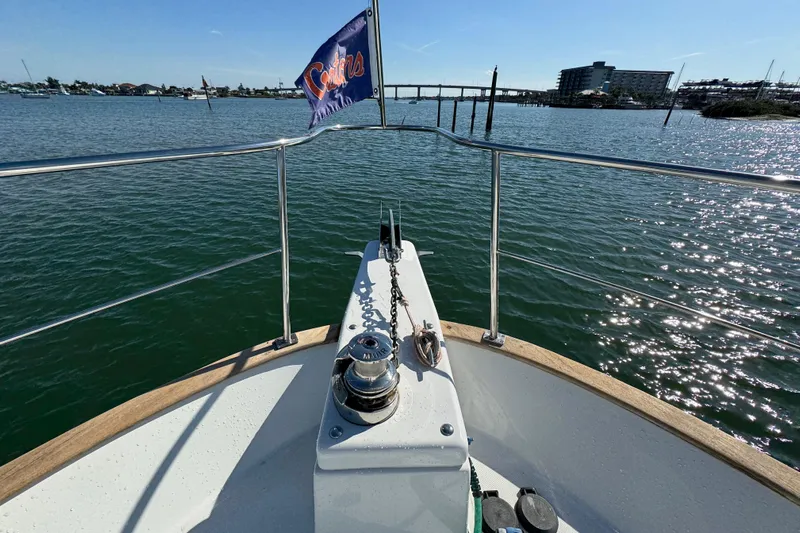  Yacht Photos Pics Bow view of 2006 Albin 40 North Sea Cutter on calm water, with a flag waving.