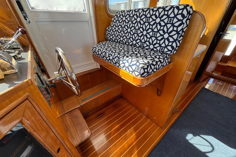  Yacht Photos Pics Interior of 2006 Albin 40 North Sea Cutter with patterned seating and wooden flooring.