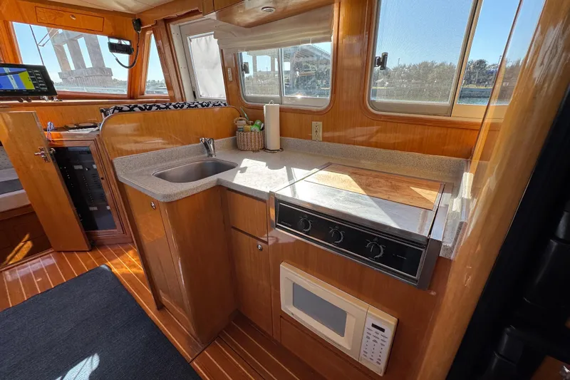  Yacht Photos Pics Compact kitchen in 2006 Albin 40 North Sea Cutter with stove, sink, and microwave.