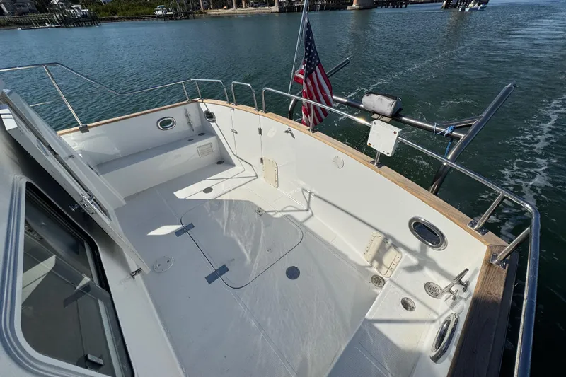  Yacht Photos Pics 2006 Albin 40 North Sea Cutter deck with American flag, cruising on calm waters.