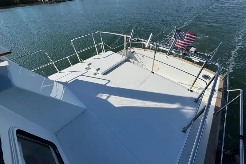  Yacht Photos Pics 2006 Albin 40 North Sea Cutter deck with railing and American flag on water.