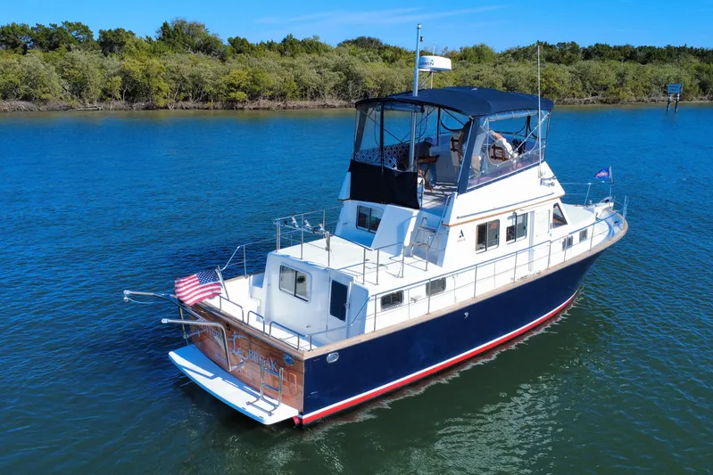  Yacht Photos Pics 2006 Albin 40 North Sea Cutter cruising on calm waters with lush green shoreline.