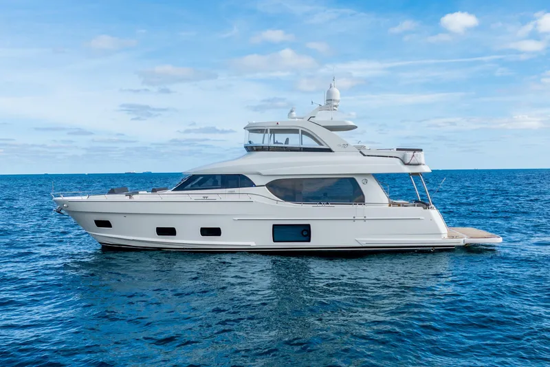Mocean Yacht Photos Pics 2021 Ocean Alexander 70E Motoryacht cruising on open sea under blue sky.