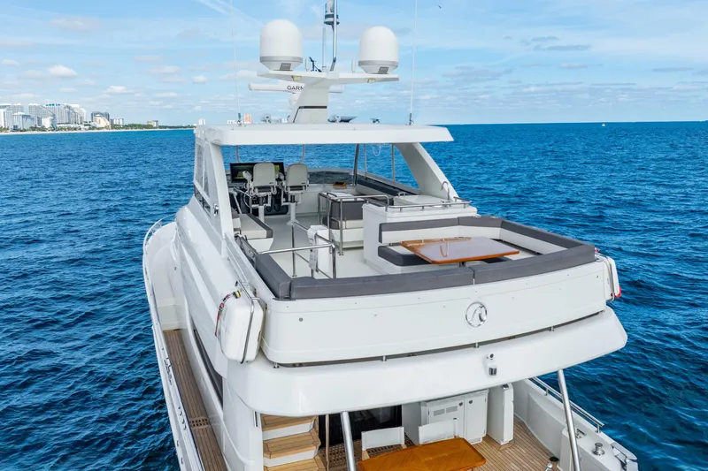 Mocean Yacht Photos Pics 2021 Ocean Alexander 70E Motoryacht cruising on blue ocean near city skyline.