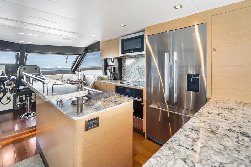 Mocean Yacht Photos Pics Luxurious kitchen interior of 2021 Ocean Alexander 70E Motoryacht with modern appliances and marble countertops.